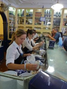 Busy staff help customers inside Pastéis de Belém, Portugal’s busiest pastry shop, Lisbon, Portugal