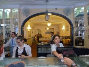Busy staff help customers inside Pastéis de Belém, Portugal’s busiest pastry shop, Lisbon, Portugal