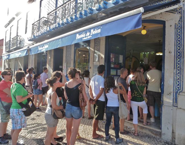 Crowds line up outside Pastéis de Belém, Portugal’s most famous pastry tart, a love affair treat, Lisbon, Portugal