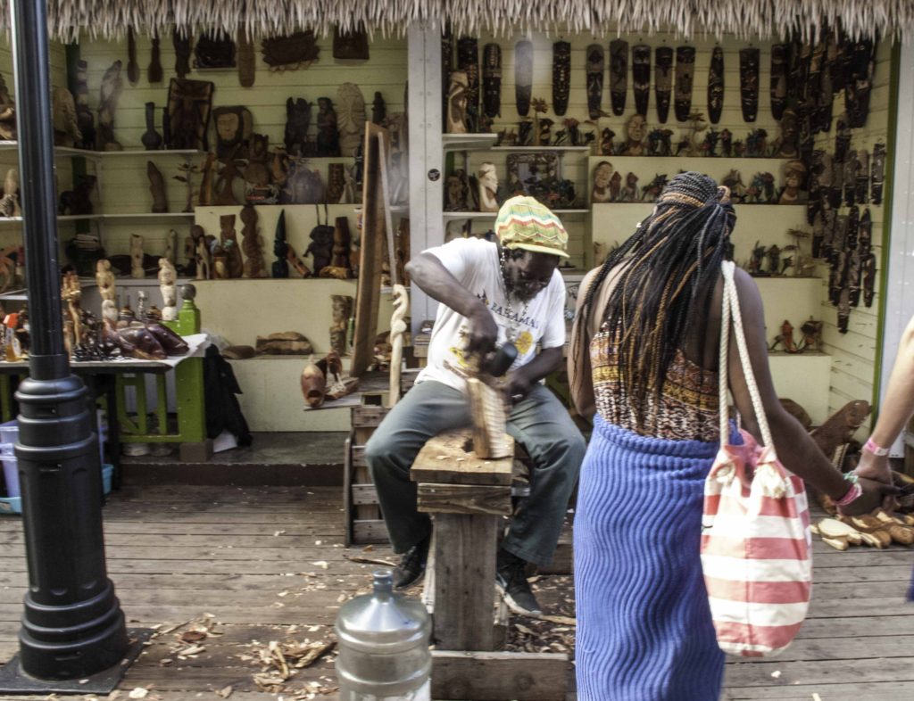 Rasta carver in the straw market of Nassau viewed during a shore excursion from Holland America Lines ms Nieuw Amsterdam