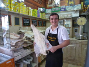 Luis Godinho talks about the merits of Portugal’s national dish, bacalhau (salted cod), at Lisbon’s famed cod store, Bacalhoaria e Manteigaria Silva, An Appetite for Lisbon, Portugal