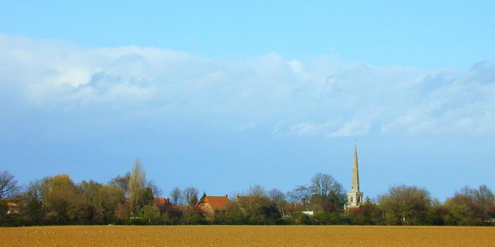 Clinton Church spire towers over the flat fenland fields