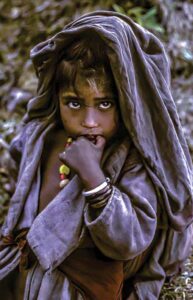 In Nepal, a young nomad girl looks with wonder at the world. (Photo: Robert Holmes)