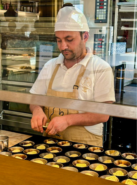 Making Pastel de Nata in a typical Lisbon cafe, Portugal