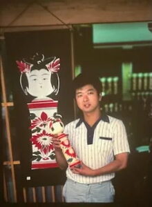 Showcasing one of the Narugo kokeshi that have been crafted for more than 150 years as a toy for children, Tohoku, Honshu, Japan.